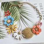 Enamel daisy flower necklace with gold-tone links and colorful flower pendants