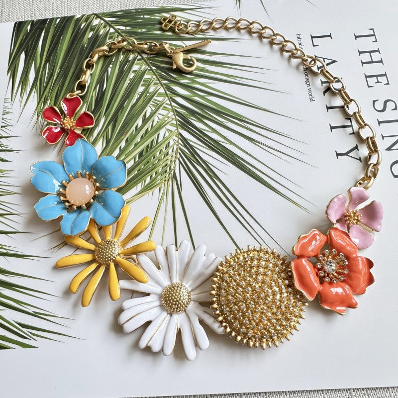 Enamel daisy flower necklace with gold-tone links and colorful flower pendants