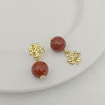 Round red agate pendant earrings with gold-tone geometric drop details