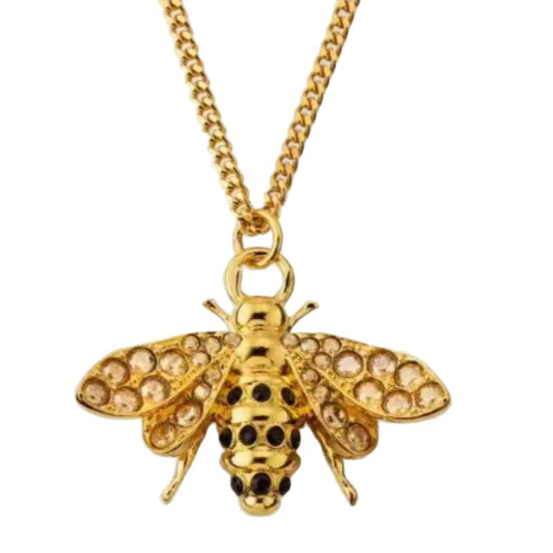 Gold curb chain with circular clasp and bee pendant, diamond-like wing stones
