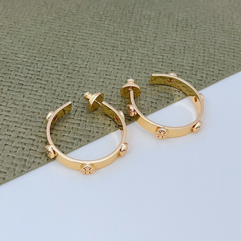 Tory Burch exquisite raised logo metal earrings
