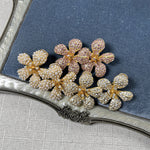 Diamond five-petal flower earrings with pink-purple pavé stones and floral drops
