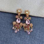 Rhinestone tassel clip-on earrings with pink stones, clear drops, and gold details