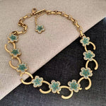 Gold-tone O-ring floral necklace with turquoise flower clusters and crystal detailing