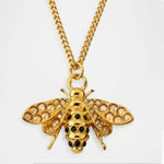 Gold bee pendant necklace featuring rhinestone-studded wings and black spot detailing