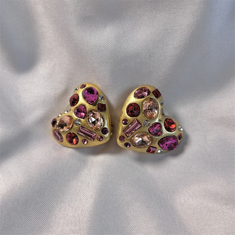 Heart-shaped crystal stud earrings in gold tone with pink, purple, and clear stones