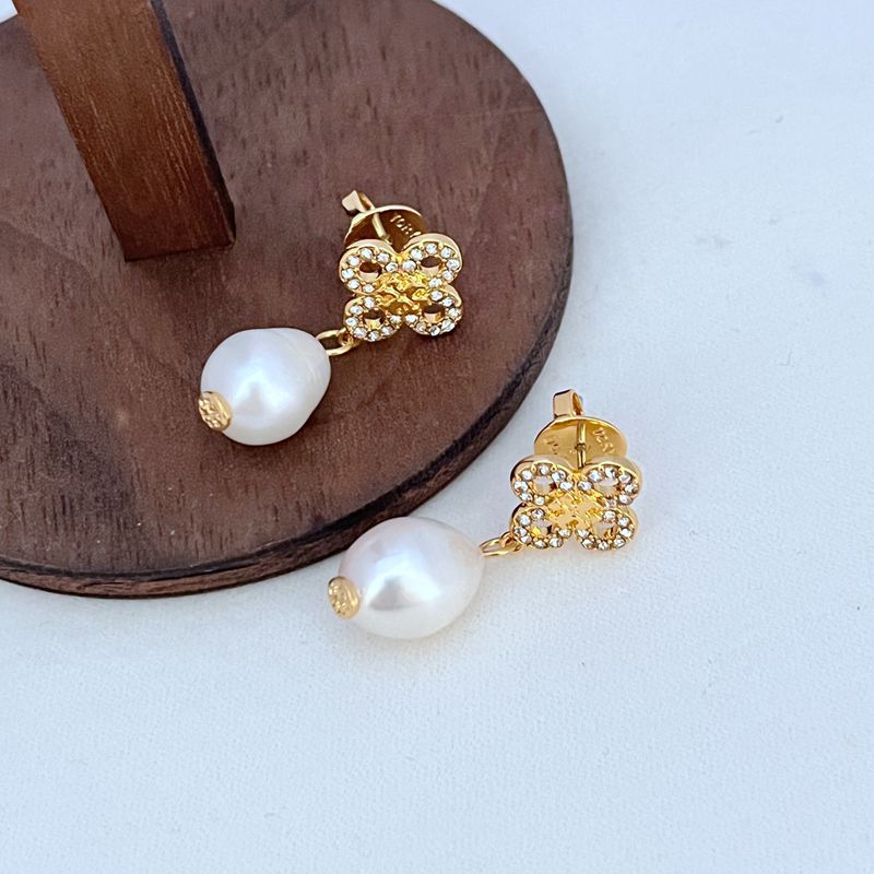 Gold four-leaf clover earrings with freshwater pearl drop and crystal-studded petals