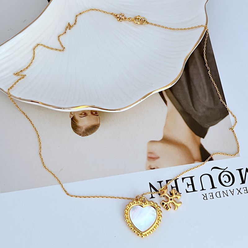 Gold layered heart pendant necklace with mother-of-pearl shell inlay and long chain