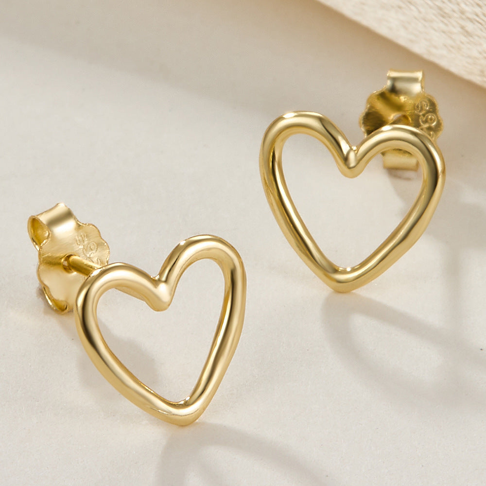 Heart-shaped stud earrings, gold tone, rounded heart outline with hollow center