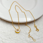Gold chain necklace with round enamel pendants and lobster clasp hardware