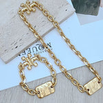 Gold chunky chain with rectangular tag and H-shaped link ends