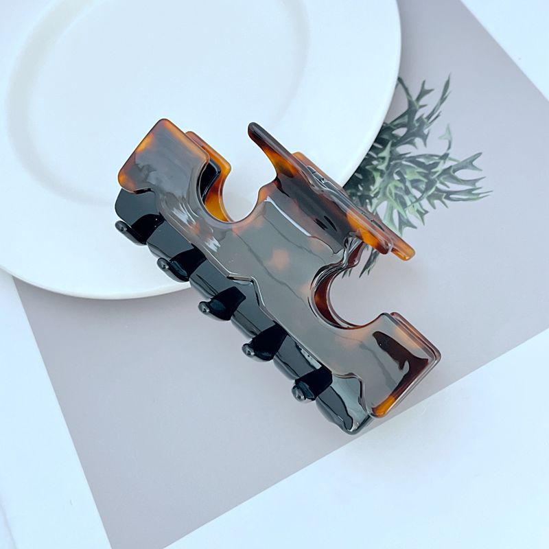 Two-tone shark T-shaped hair clip, gray black base with amber accents