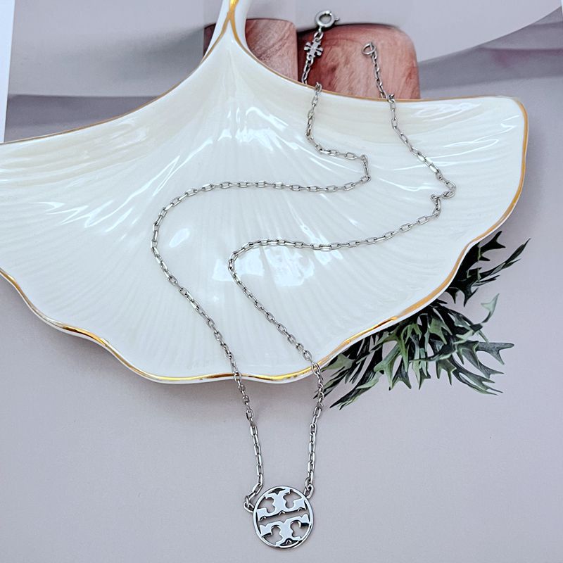 White gold minimalist openwork logo pendant necklace with round emblem on chain