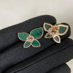 Butterfly enamel earrings with green petals, heart center charm, and gold-tone prongs