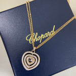 Heart pendant necklace with diamond pavé triple-heart design on a gold chain