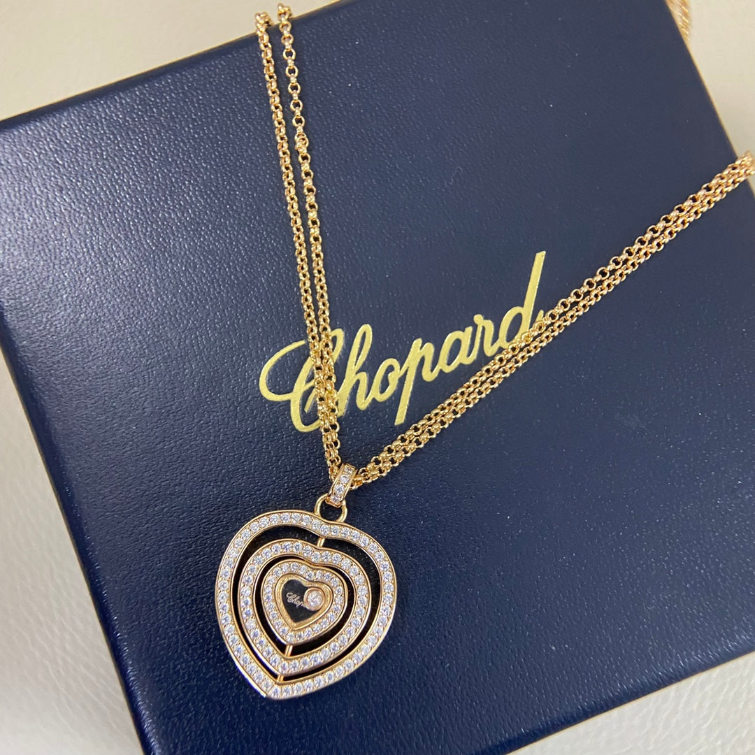 Heart pendant necklace with diamond pavé triple-heart design on a gold chain