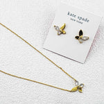 Butterfly stud earrings set on card, goldtone with clear crystals and black wings