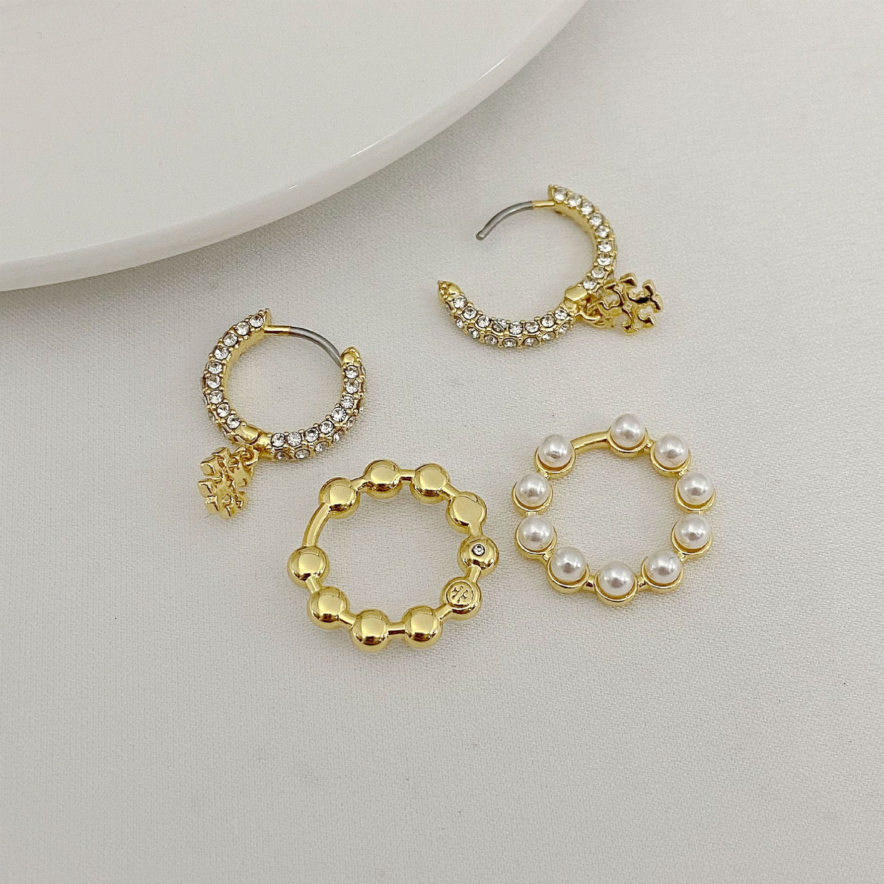 Set of hoop pendant earrings with gold-tone rhinestone hoops and white pearl hoops