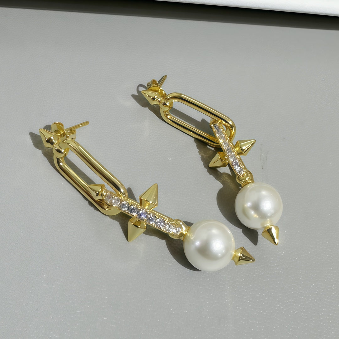 Gold-tone earrings with white pearls and glitter bar plus ribbon bow tips