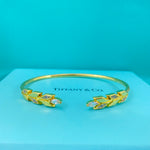 Gold-tone open leaf bangle with diamond-encrusted leaf accents
