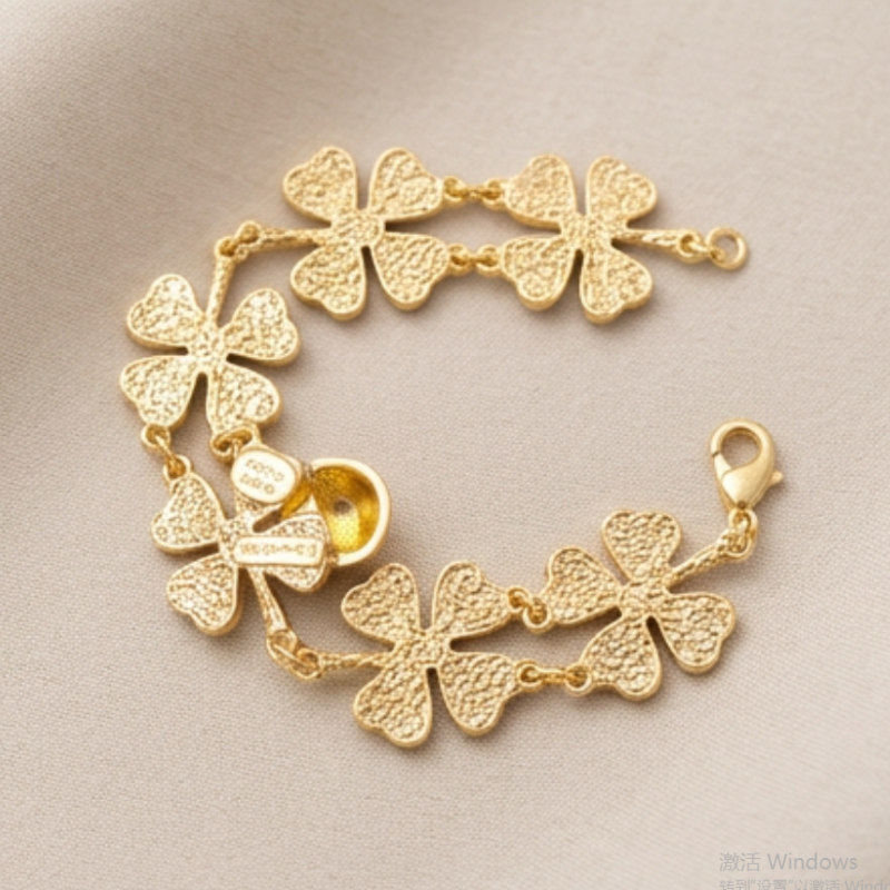 Gold-tone bracelet with textured four-leaf clover charms and ladybug charm
