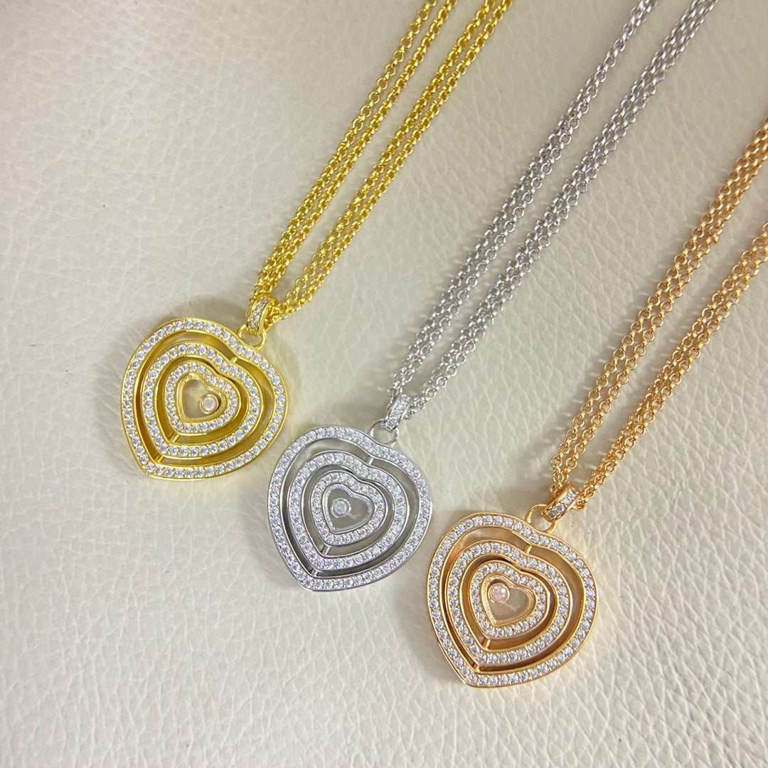 Triple heart pendant necklace with diamond pavé heart pendants on gold and silver chains