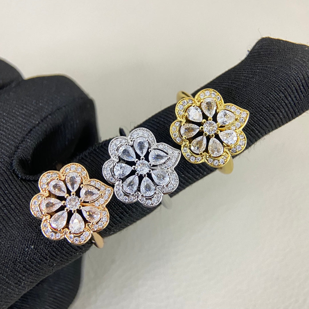 Openwork petal diamond rings on gloves: gold and white gold with clear stones