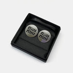 Round silver/white gold metal stud earrings with miu miu logo cutouts