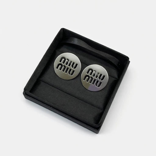 Round silver/white gold metal stud earrings with miu miu logo cutouts
