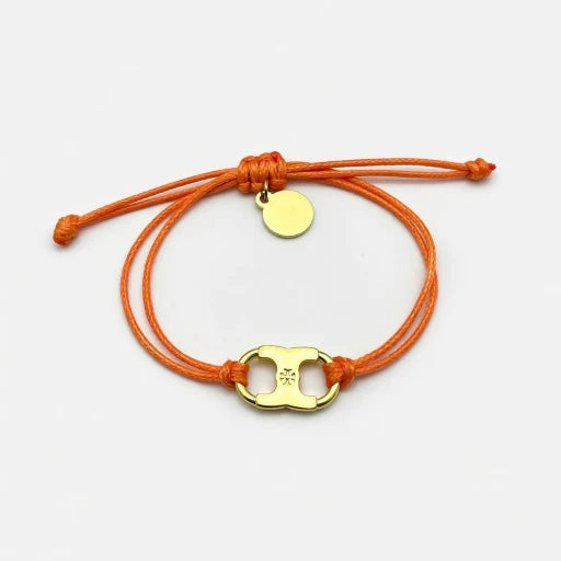 Woven enamel bracelet with orange braided cord and gold logo charm with enamel center.