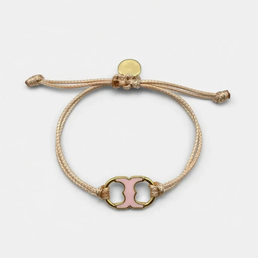 Adjustable drawstring bracelet with pink enamel toggle charm on beige cords