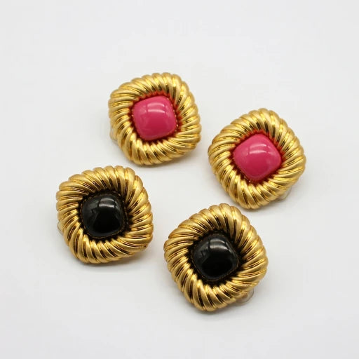 Gold-tone scalloped stud earrings with pink and black cabochon centers, set of two