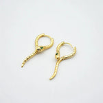 Gold-tone snake hoop ear cuffs with green crystal eyes and hinged clasp hooks