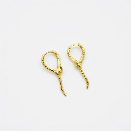 Gold-tone snake ear cuffs with green crystal accents and curved dangling ends