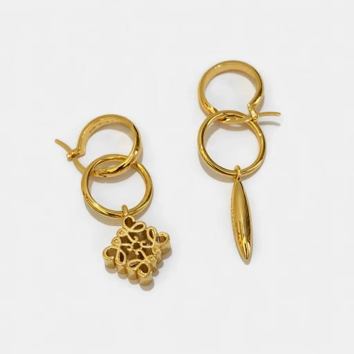 Gold asymmetrical hoop earrings with bullet drop and small square filigree ornament