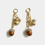 Gold-tone drop earrings with squirrel charms and brown tassel pinecone dangles