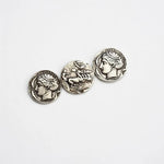 Distressed silver coin brooch with three round engraved profile discs