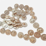 Distressed silver coin brooch with many round engraved discs in a curved layout