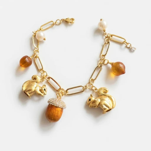 Gold-tone charm bracelet with squirrel, pinecone, acorn and pearl-style beads