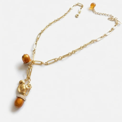 Gold pendant necklace with squirrel charm and pinecone enamel bead drops