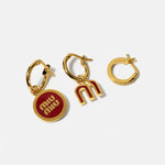 Three-piece enamel logo earrings set in gold tone with red details