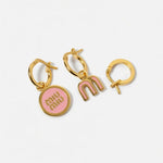 Three-piece enamel logo earrings set in gold tone with pink details