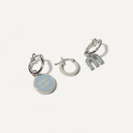Three-piece enamel logo earrings set in silver tone with light blue details