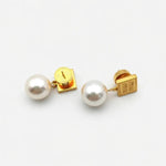 Gold Miu Miu square tag pearl earrings, side view showing metal post and pearl