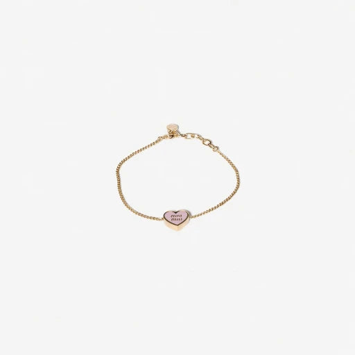 Gold-tone adjustable bracelet with pink enamel heart charm and Miu Miu logo oval