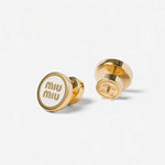 Gold-plated round enamel stud earrings, front and back view, with dark logo center.