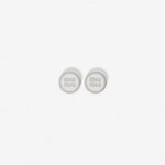 Silver-tone round enamel stud earrings with light gray 'miu miu' logo center.