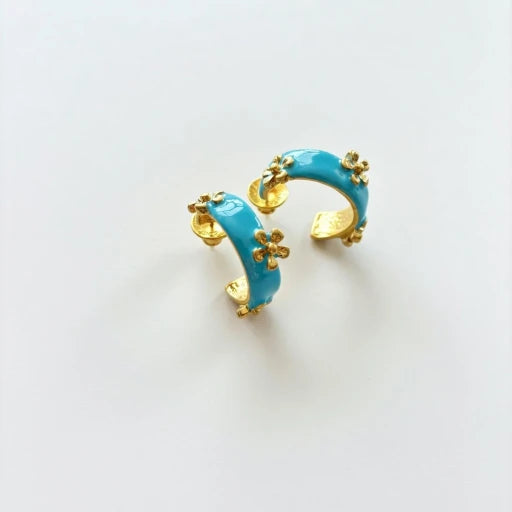 Blue enamel C hoop earrings with small raised flower embellishments in gold tone