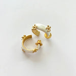 Cream enamel C-shaped hoop earrings with gold-tone raised flower details