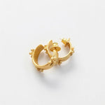 Gold-tone C hoop earrings with embossed flower accents and stud posts